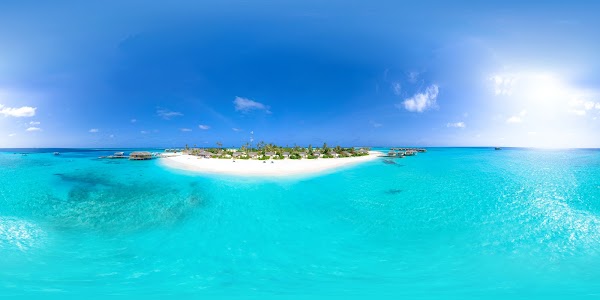 Aerial panorama of You & Me Maldives island in Raa Atoll, white sand beach, palm trees and turquoise lagoon under a clear